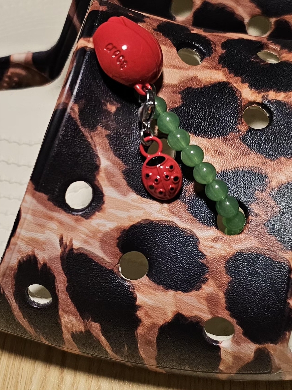 Two Red Rose Crocs Jibbitz With A Ladybug On Stim Made Of Green Beads